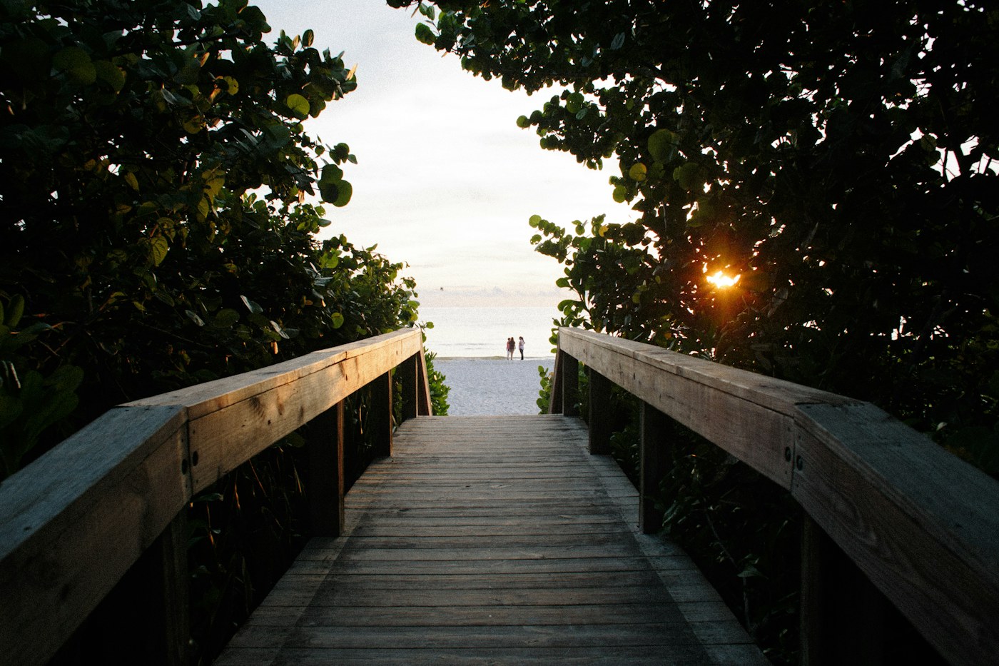 Boardwalk leading through the dunes to the beach at sunset in Naples, Florida