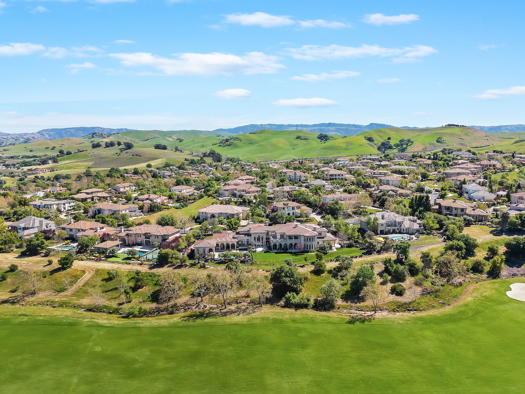 Aerial view of Ruby Hill guard-gated golf community Pleasanton CA with Jack Nicklaus course fairways at golden hour