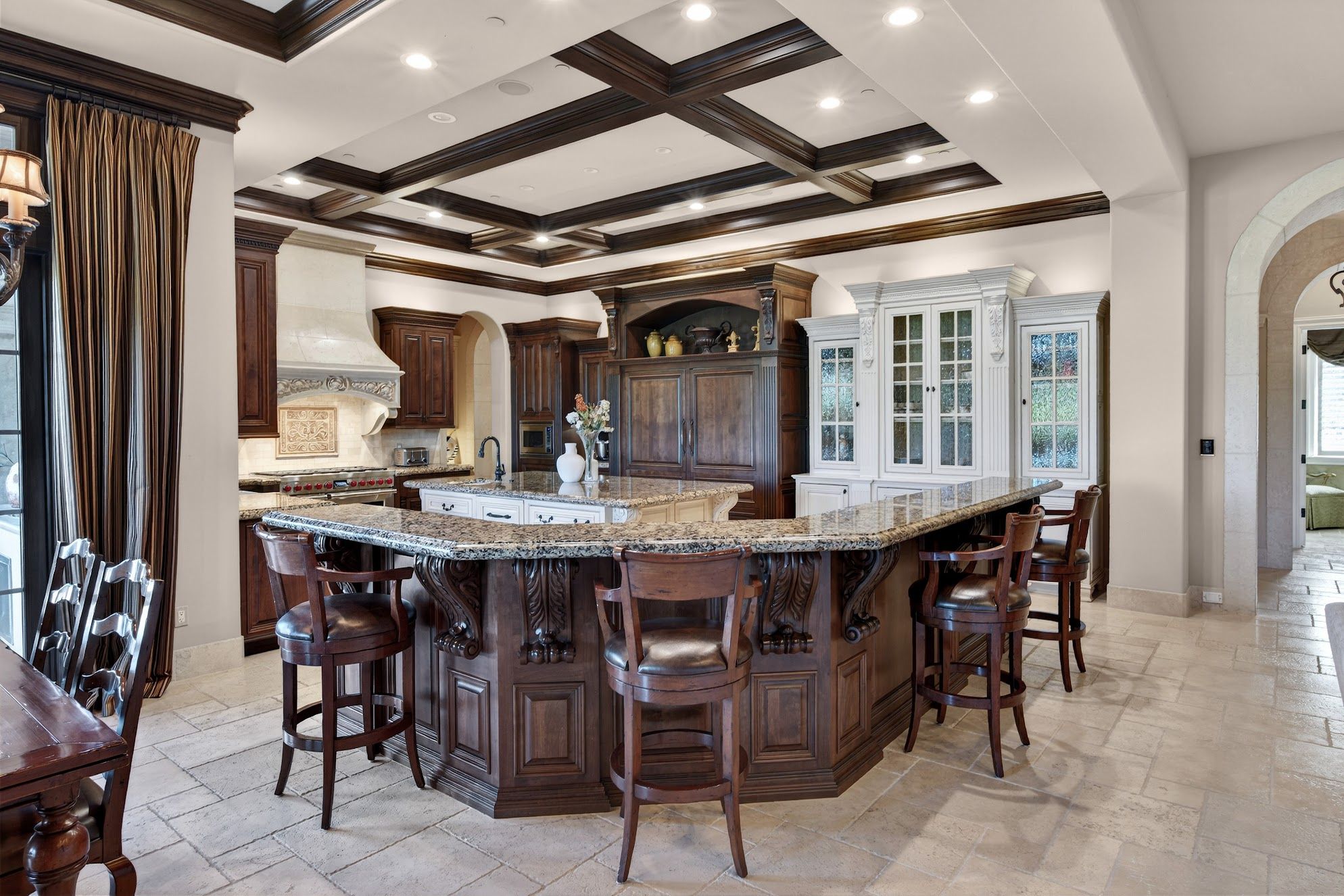Interior of Ruby Hill Pleasanton luxury estate showing open-concept kitchen with stone counters and golf course views through rear windows
