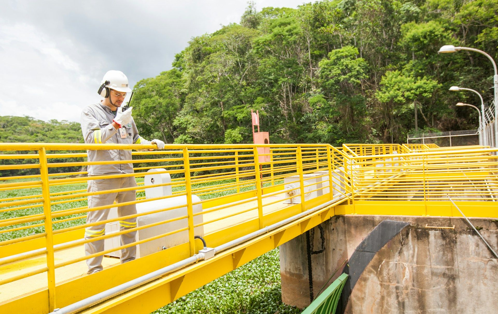 Man in a safety vest on a bridge