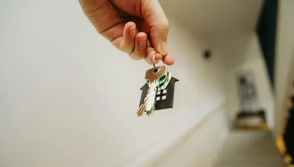 person holding house keys