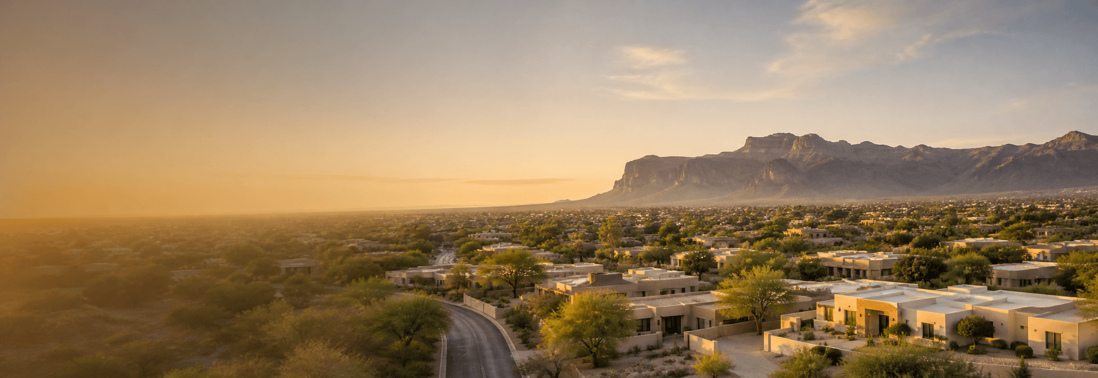 Warm Arizona East Valley residential neighborhood at golden hour with mountain ridgeline on the horizon