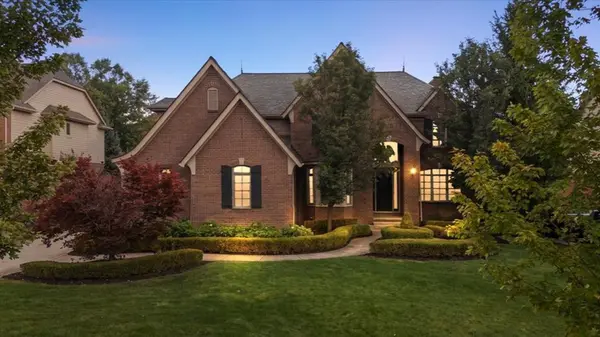 Luxury brick home at dusk in Oakland Township, Michigan