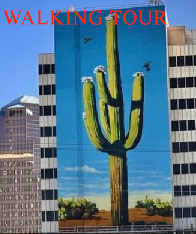 Large mural of a saguaro cactus painted on the side of a downtown Tucson building, viewed during a guided walking tour.
