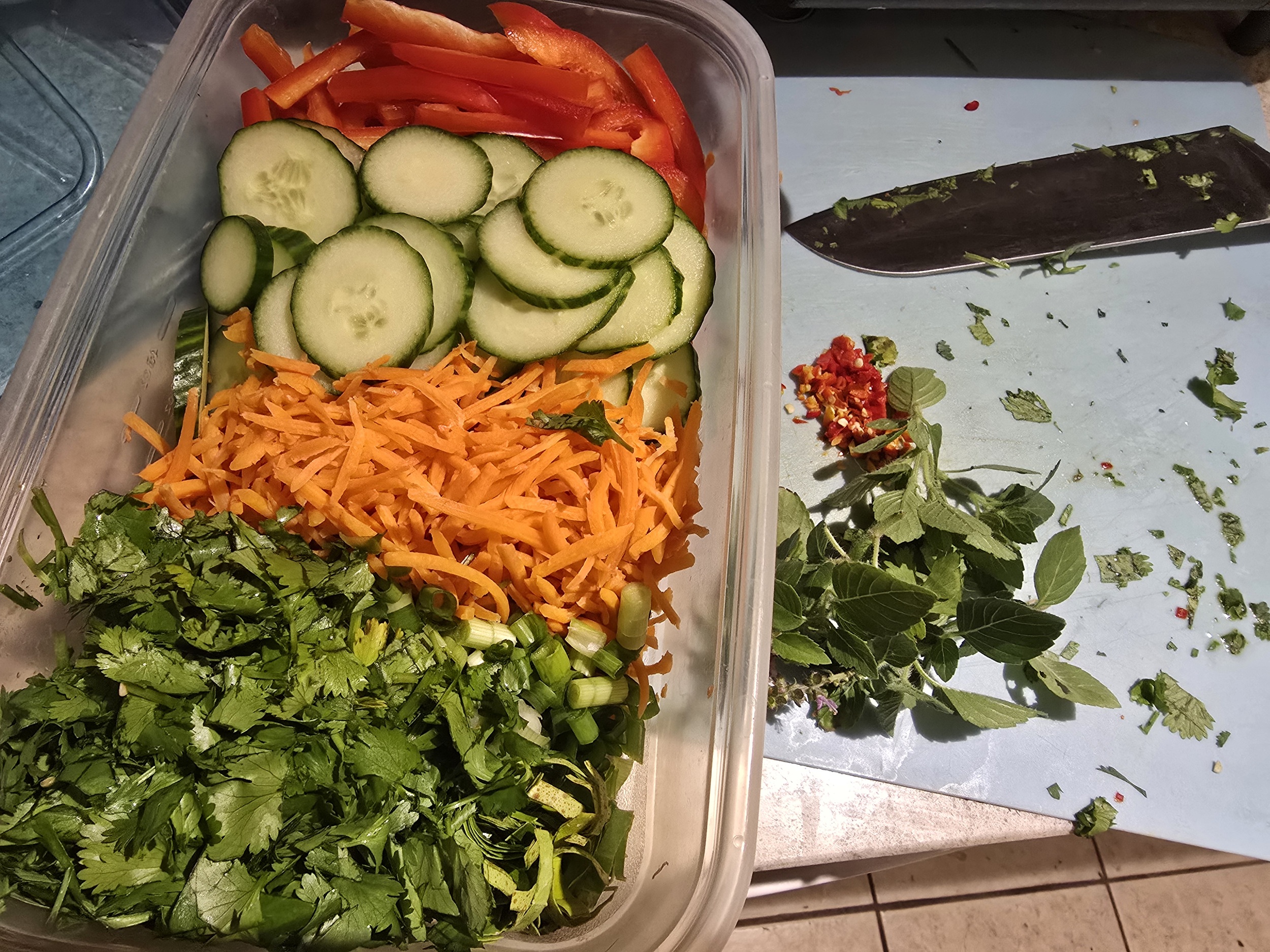 Chopped fresh vegetables and herbs for the noodle bowl