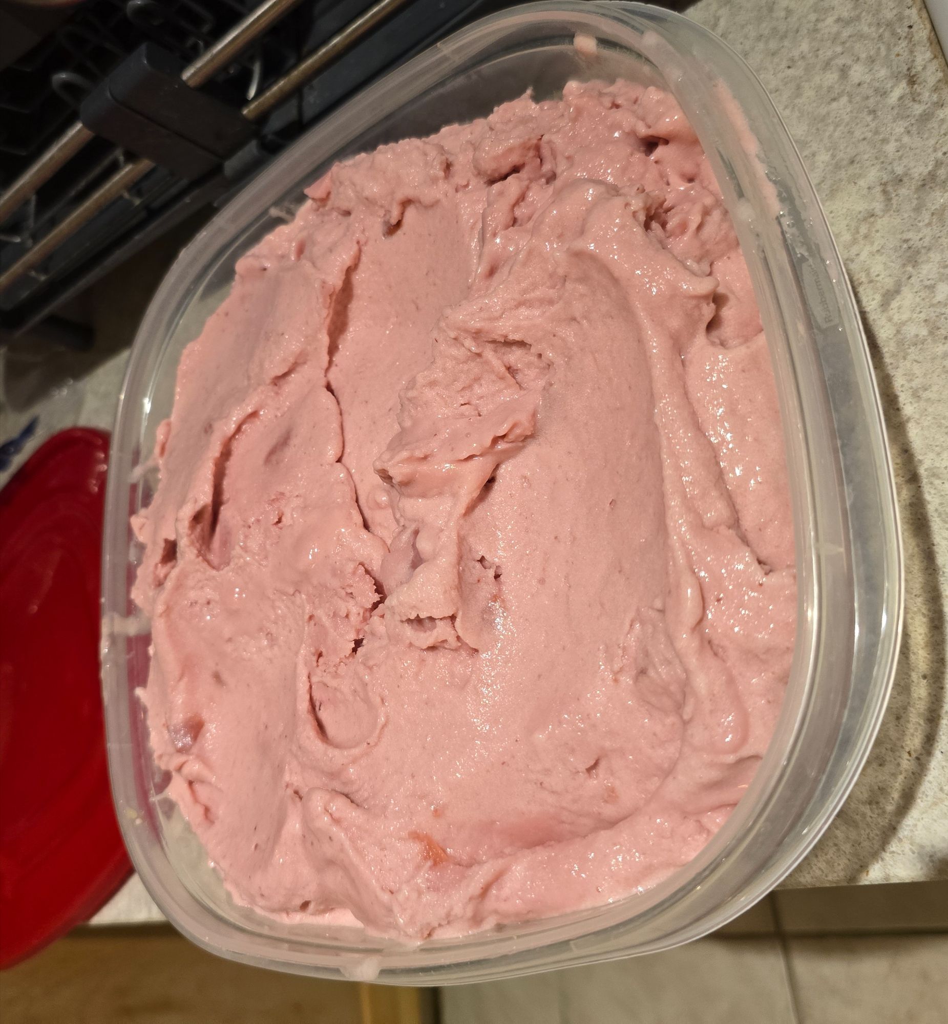 Churned peach and plum coconut ice cream in container