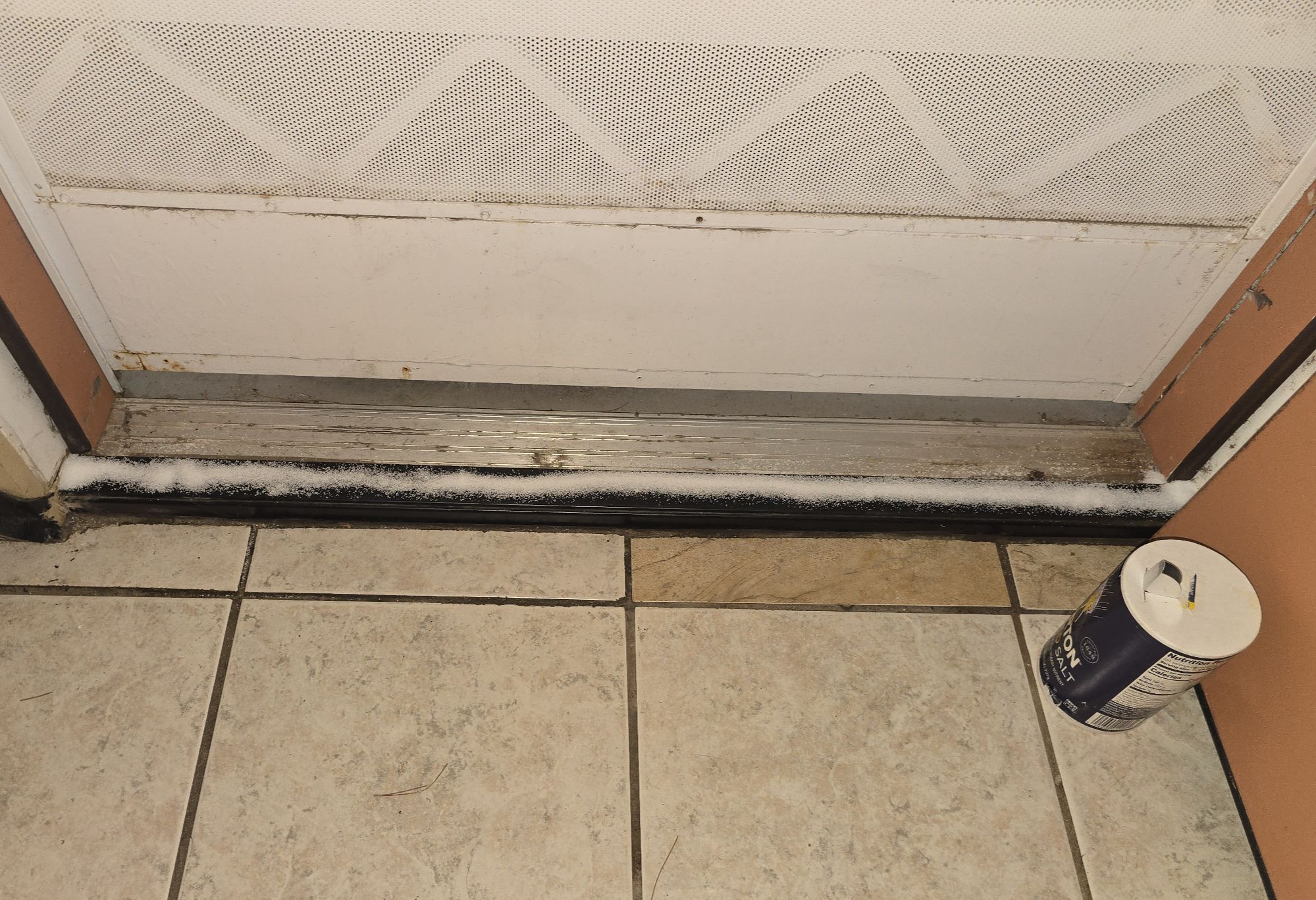 A thin line of salt poured across a door threshold