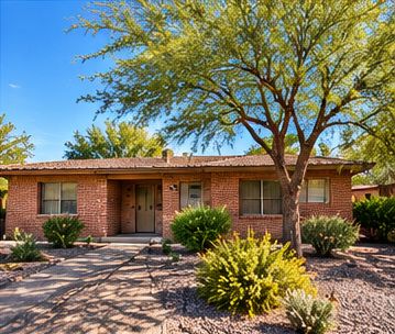 Established single-story brick ranch home with mature landscaping in a Tucson-style neighborhood.