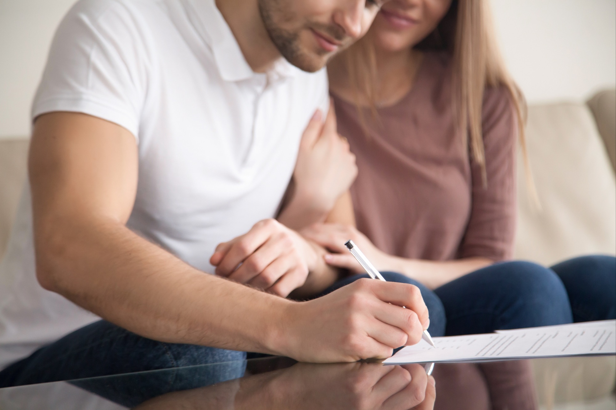 Couple sitting signing papers