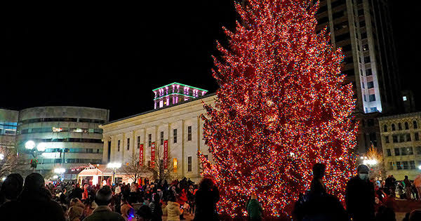 Crowded Street with Red lit Tree