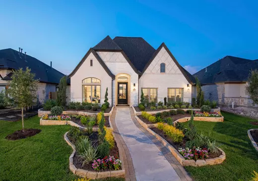 Modern yet cozy home exterior in an active adult neighborhood, representing the comfort and lifestyle of 55+ living. Representation only