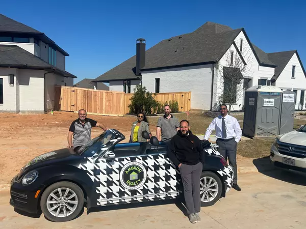 alt = "Grange community with Ambrosi Realty agents with the Houndstooth Bug Car"