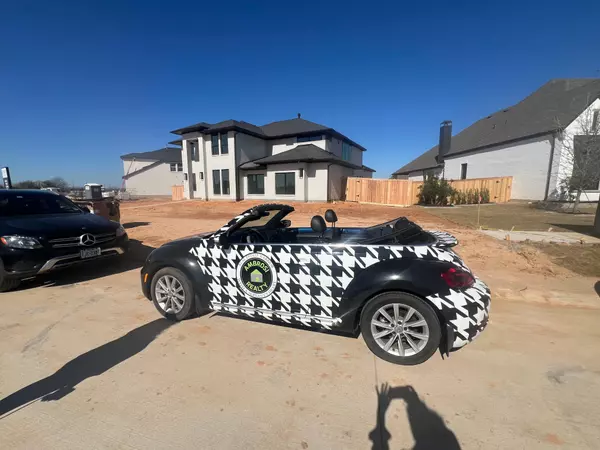 alt = "Grange community - Katy Small Town Living with sample houses and houndstooth bug car"