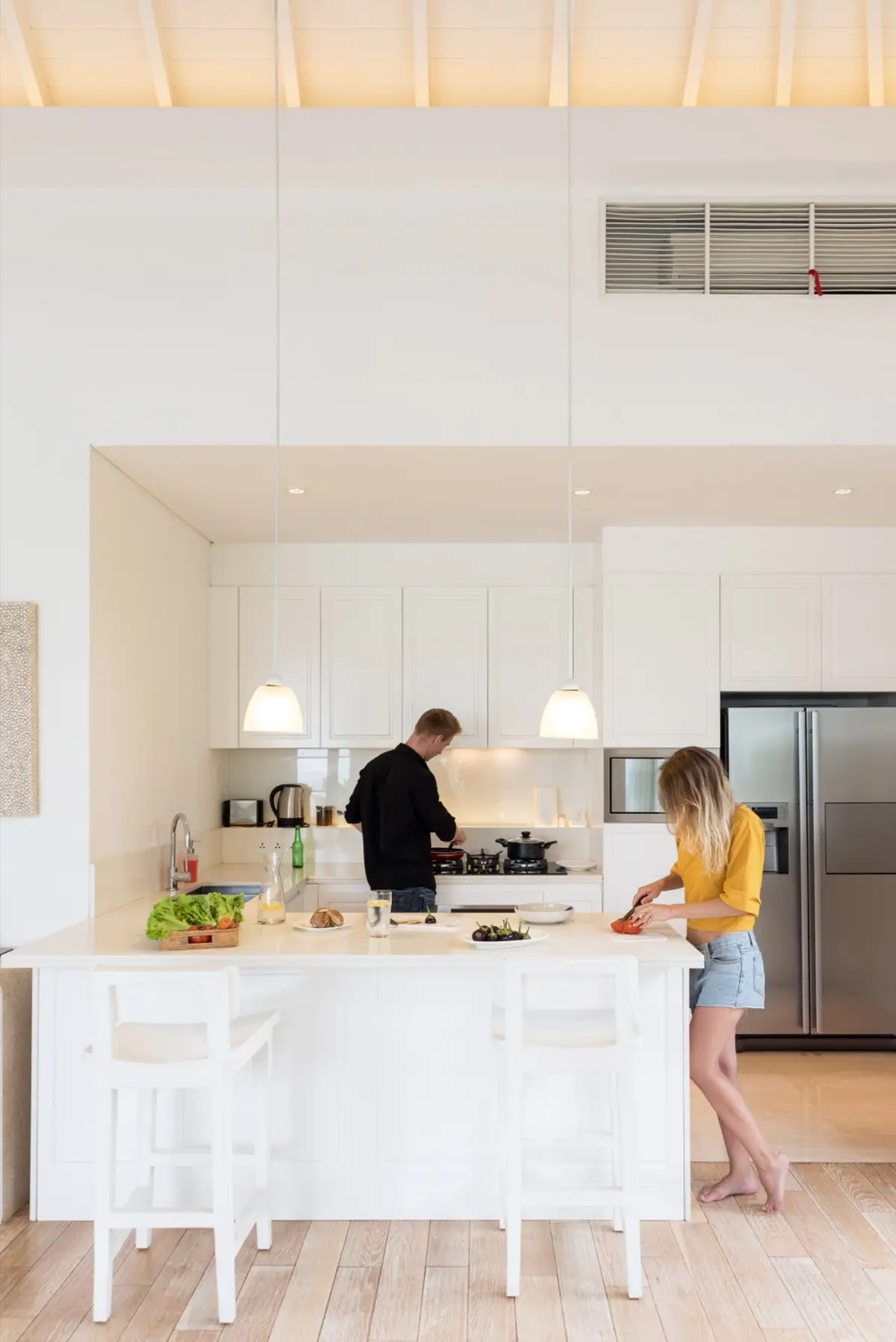 couple-making-lunch-on-a-white-kitchen-at-home-will flanagan realty group
