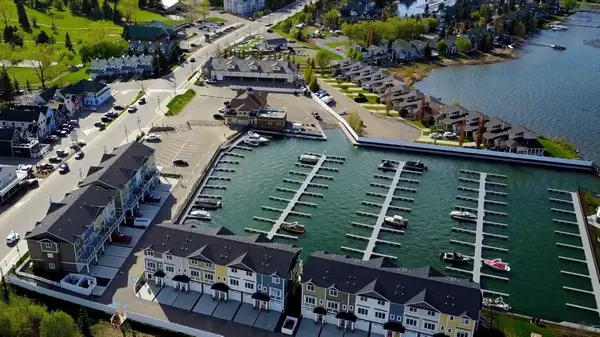 Aerial view of Sylvan Lake marina in Central Alberta showing waterfront condos, boat docks, and lakeside homes near the Sylvan Lake shoreline and town centre.