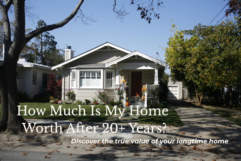 A single-story Craftsman-style home with beige siding, white trim, and a red front door, surrounded by a neatly landscaped yard with green grass and trees, under a clear blue sky.