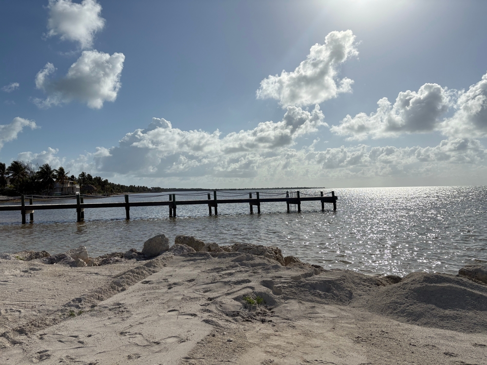 Wooden pier extending over calm water at sunrise on Grassy Key in the Middle Florida Keys