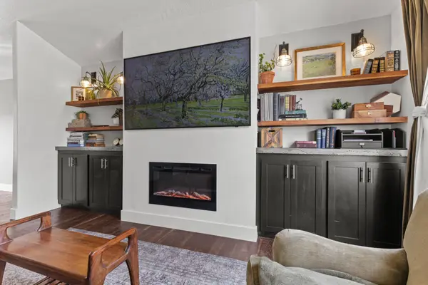 Custom built-ins, floating shelves surrounding a plaster finished fireplace.  TV components are tucked behind the wall for a flawless esthetic. 