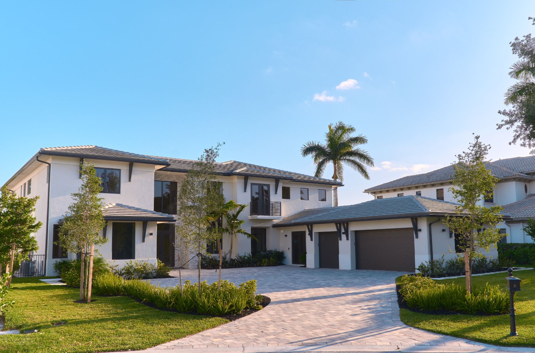 Luxury home in Weston Florida with manicured summer curb appeal and tropical landscaping