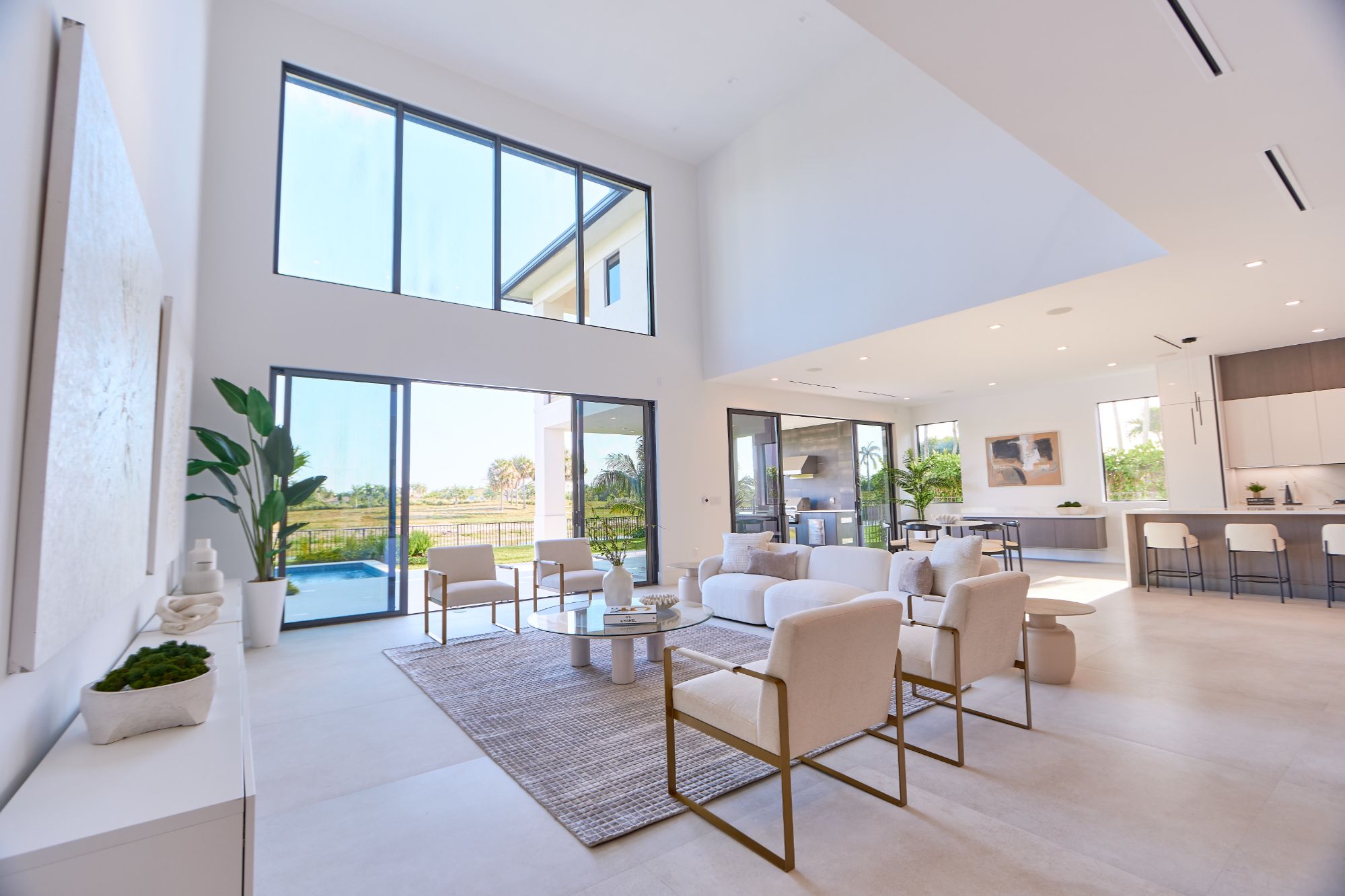 Staged living room in a Weston FL luxury home with natural light and pool view.