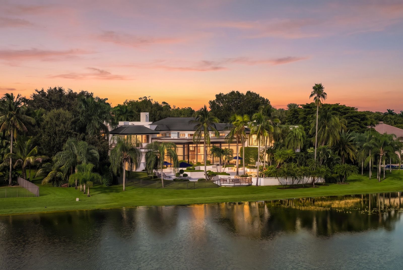 Modern luxury lakefront estate in Weston FL at golden hour.