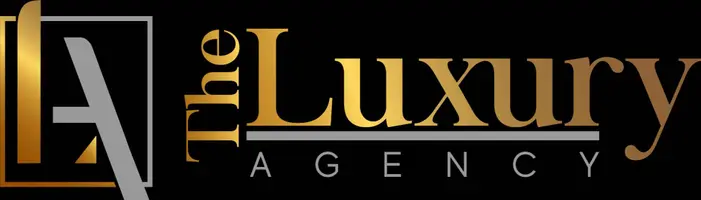 Logo for The Luxury Agency featuring a stylized modern gold and black and silver logo