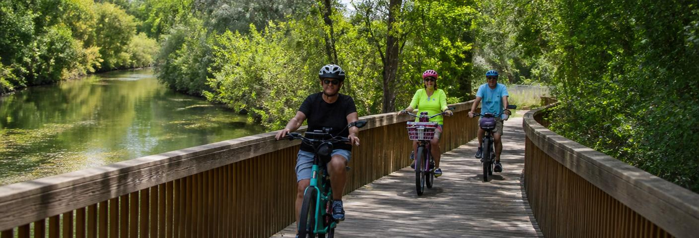 Cyclists on the Weber River Parkway Trail boardwalk in South Weber, Utah