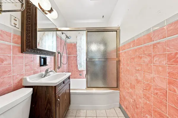 Bathroom with shower and tub in home for sale at 3763 S 20th Pl, Milwaukee, WI 53221