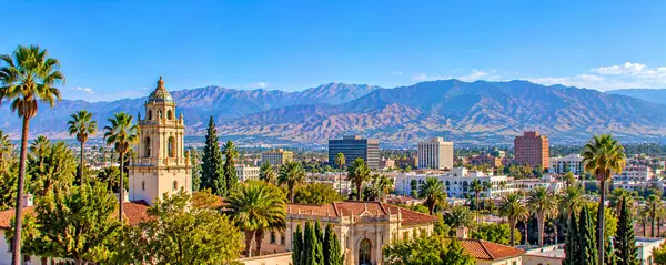 Palm-Lined Spanish-Style Cityscape with Mountains