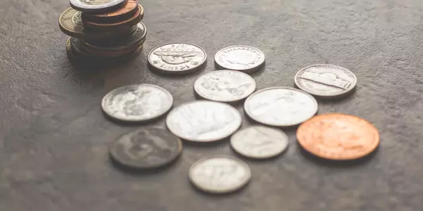 Coins representing J Castle Group's commission structure