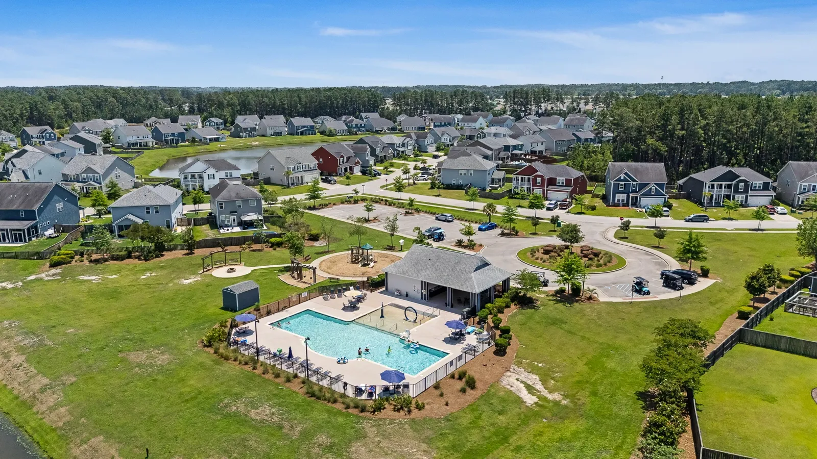 Aerial view of Cane Bay Plantation community in Summerville SC showing neighborhood pool amenity center and single-family homes