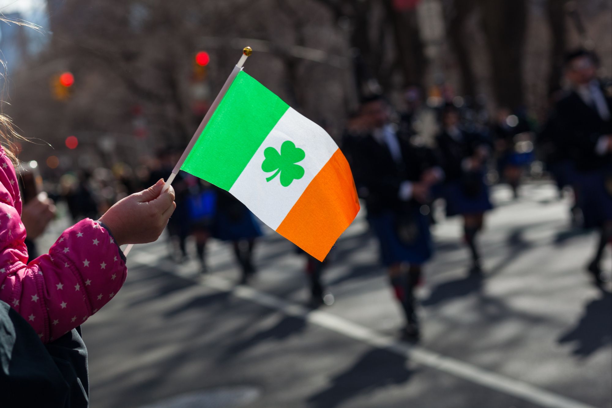 Families and friends celebrating South Jersey St. Patrick’s Day Events with live music, Irish flags, and festive outfits.
