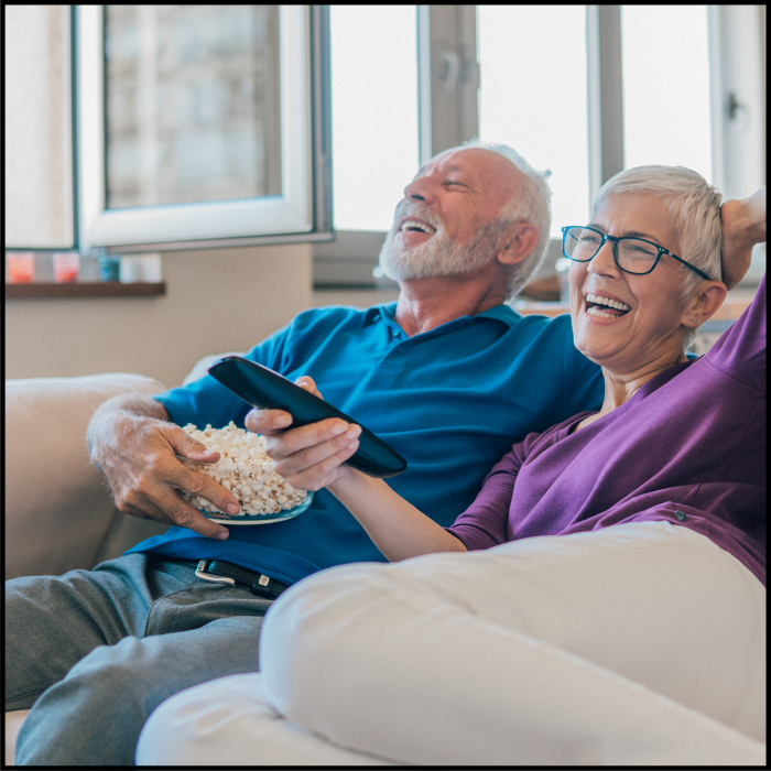 relaxed couple eating popcorn