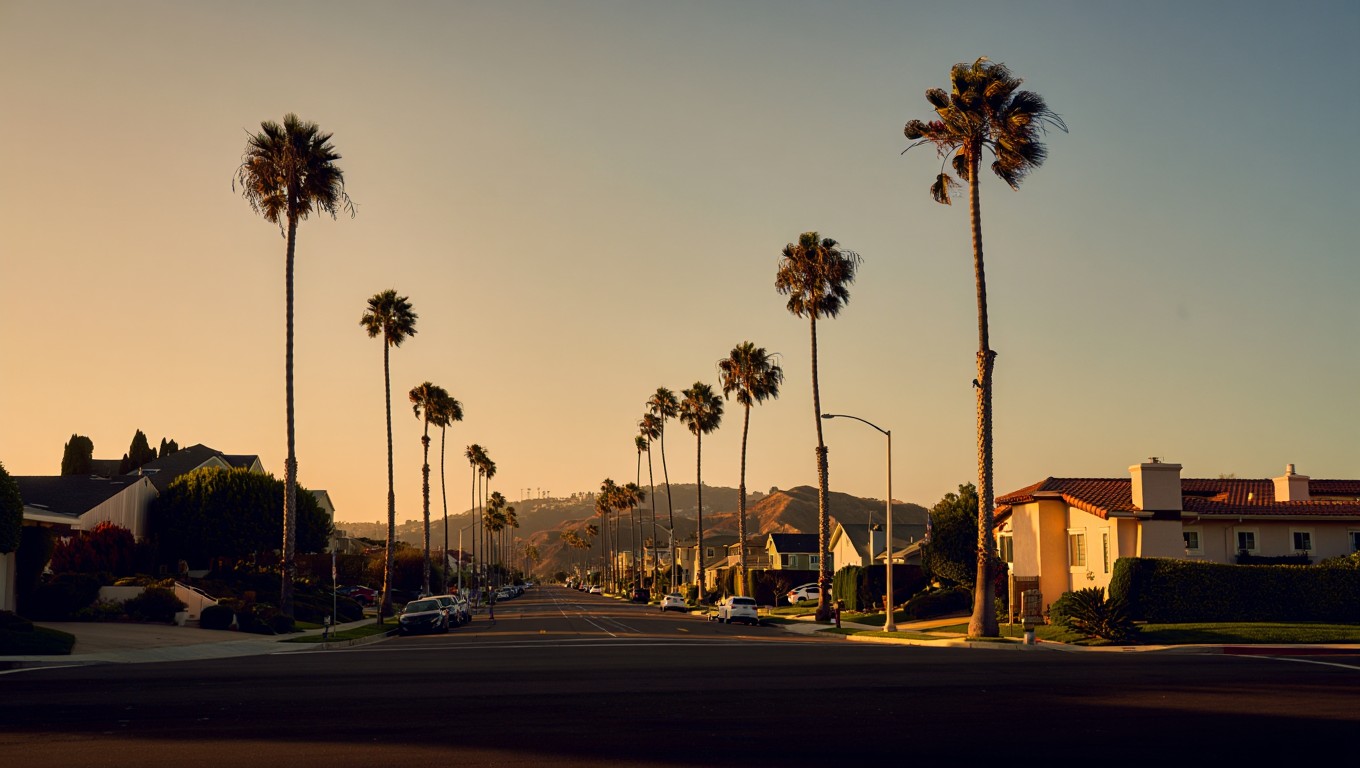 Golden hour street scene with San Diego palms and hills, conveying a seasonal shift as listings cool while buyers stay active ~ Week Ending Sept 28, 2025.