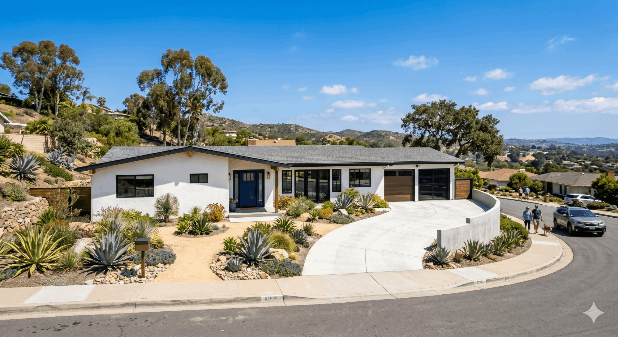 Modern renovated mid-century ranch home in a San Diego suburban neighborhood with professional xeriscaping and a navy blue door.