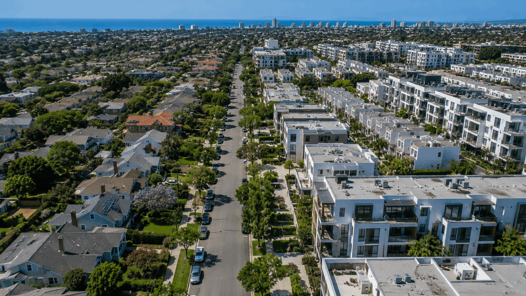 Aerial view of a San Diego neighborhood showing detached single-family homes on the left and modern condo and townhome buildings on the right, with the Pacific Ocean visible in the background. Image generated with ChatGPT for the HomeCrave San Diego Housing Market Update, week ending May 10, 2026.