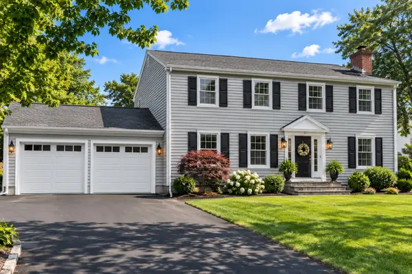 Gray garrison colonial home with two-car garage in Enfield, Connecticut