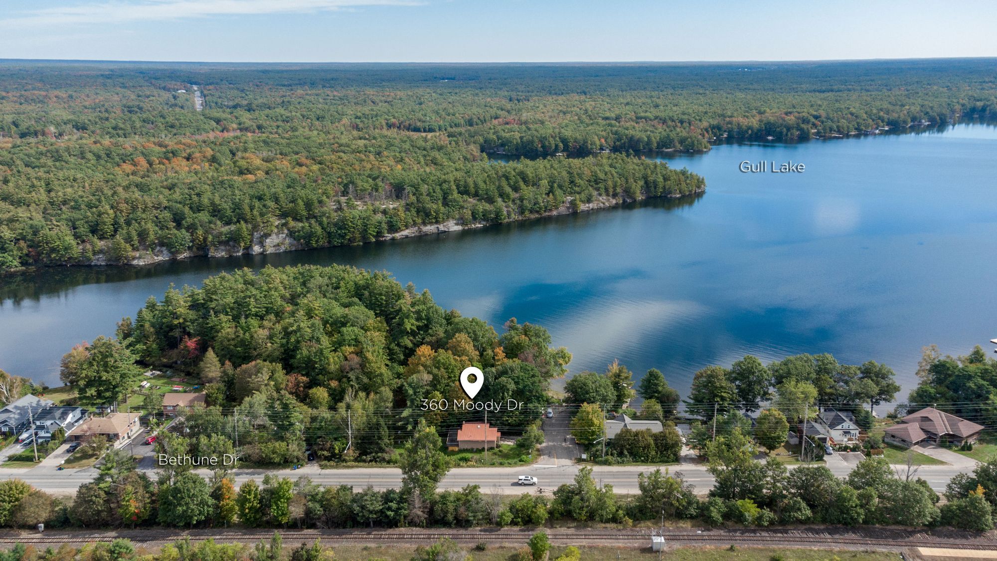 Aerial view over Gull Lake toward the Moody Drive shoreline in Gravenhurst