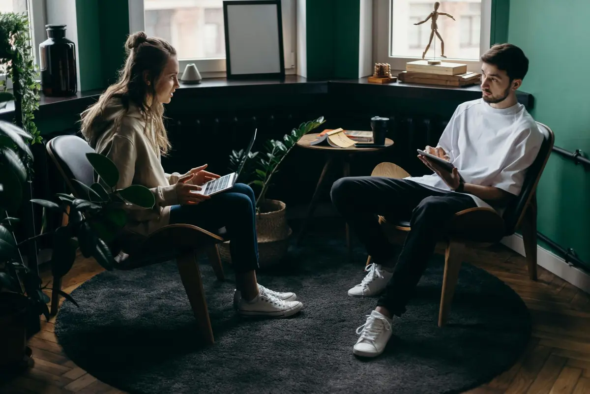 Couple planning their home purchase on computers with Arnie and Tina Sharp
