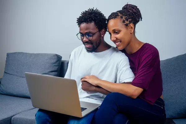 portrait-of-an-happy-couple-using-a-laptop-compute-2024-10-31-04-18-42-utc