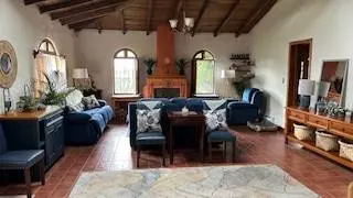 Spacious living room with fireplace and natural light in Cotacachi Ecuador property