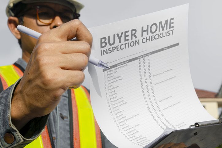 Person holding a home buyer inspection checklist in Calgary, AB 