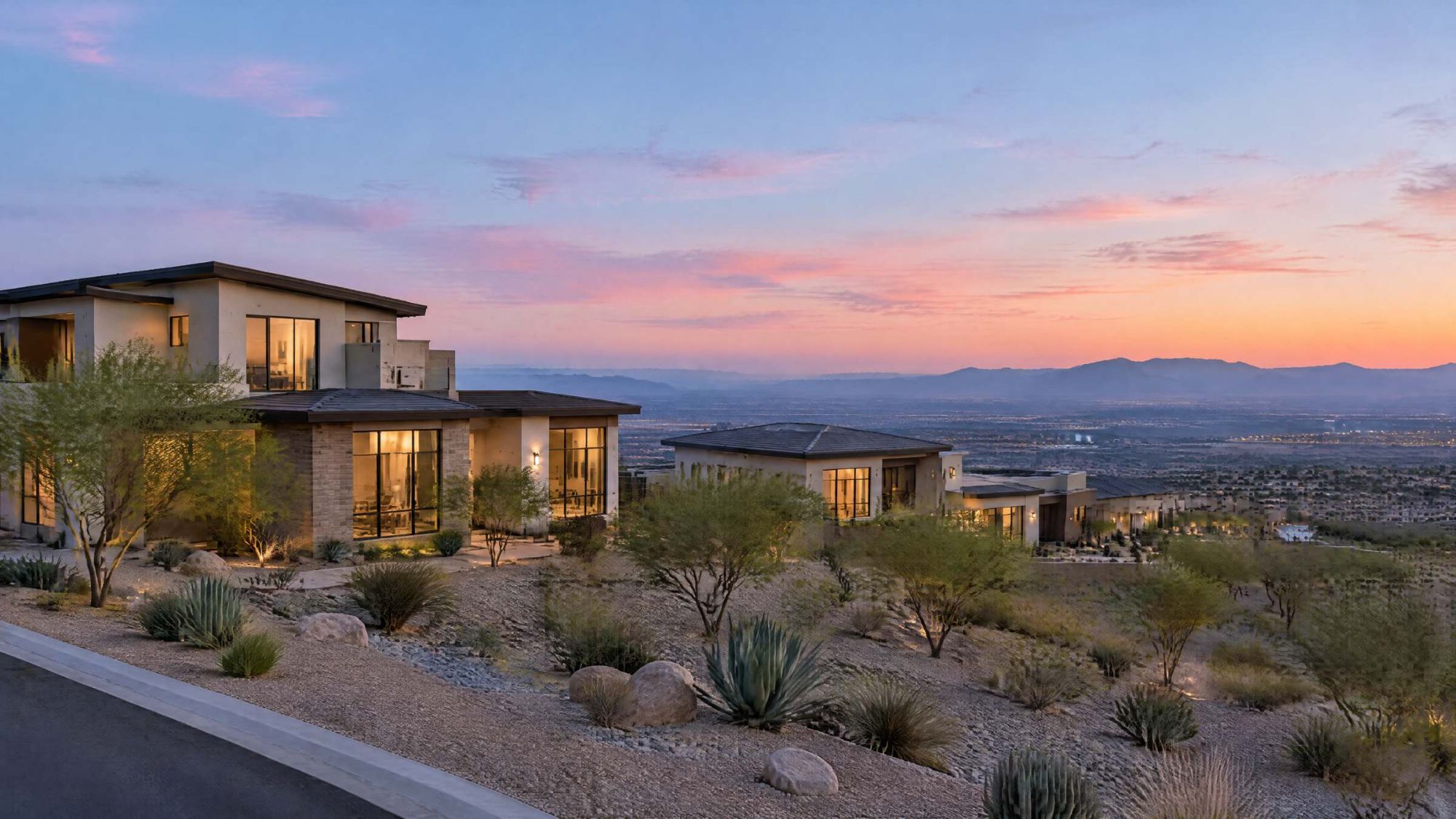 Illustration of newer two-story desert homes on high ground, looking out over a valley at dusk.