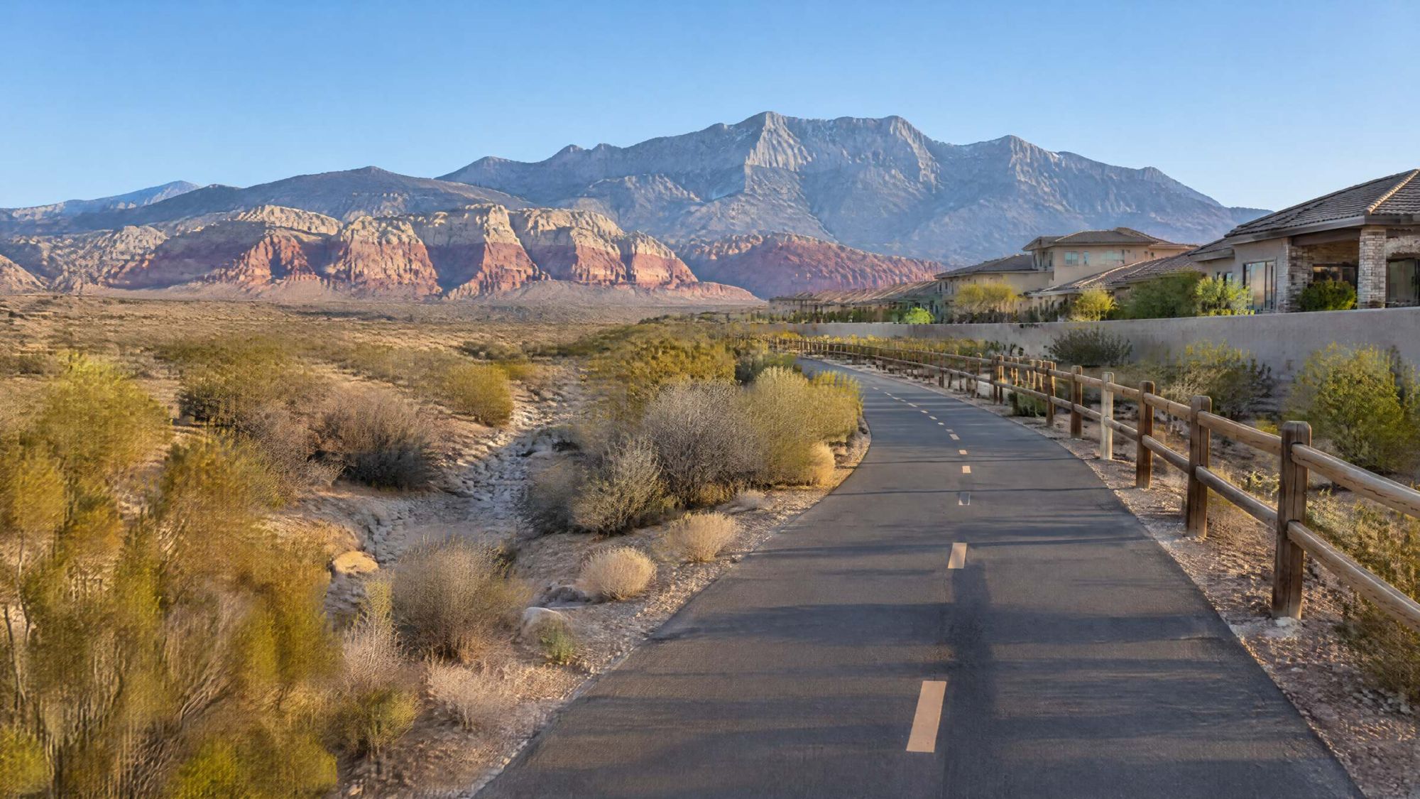 Illustration of a paved desert path beside newer homes with red rock cliffs ahead.