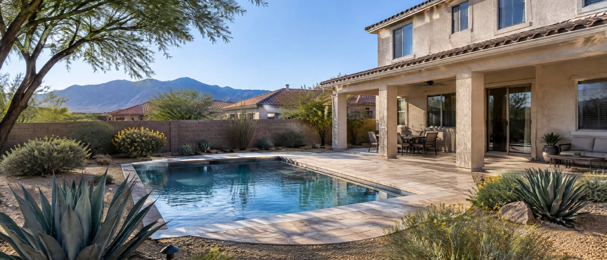 Illustration of a desert backyard with a covered patio, a small pool and low-water plants.
