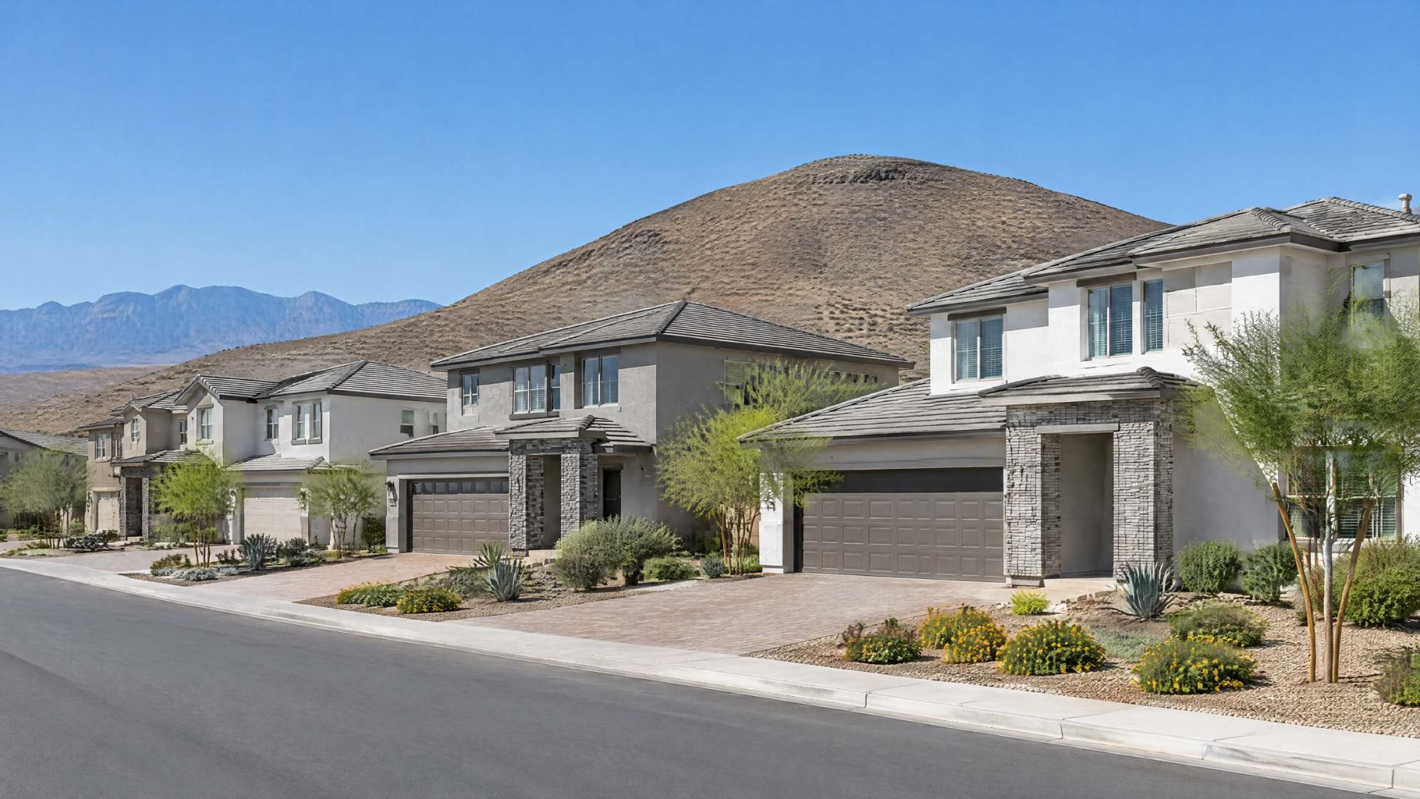 Illustration of newer two-story homes in the southwest Las Vegas valley, with a rounded brown hill behind.