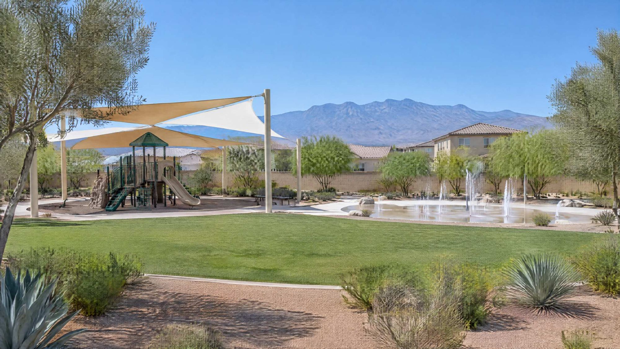 Illustration of a desert neighborhood park with shade sails, a splash pad and mountains behind.