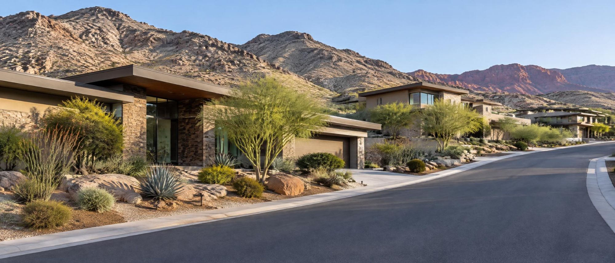 Illustration of desert contemporary homes on a quiet street, with rocky foothills behind.