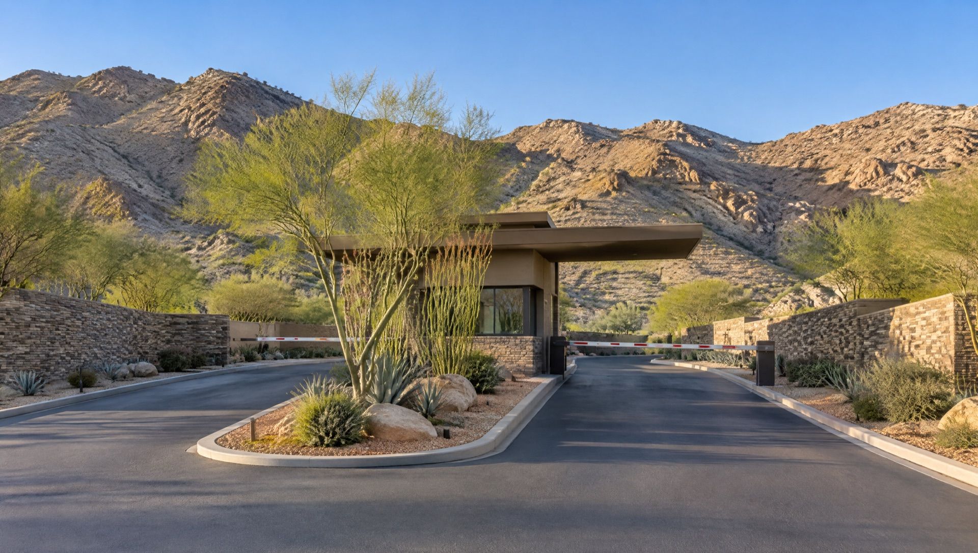 Illustration of a guard-gated community entry with a stone gatehouse and desert foothills behind.