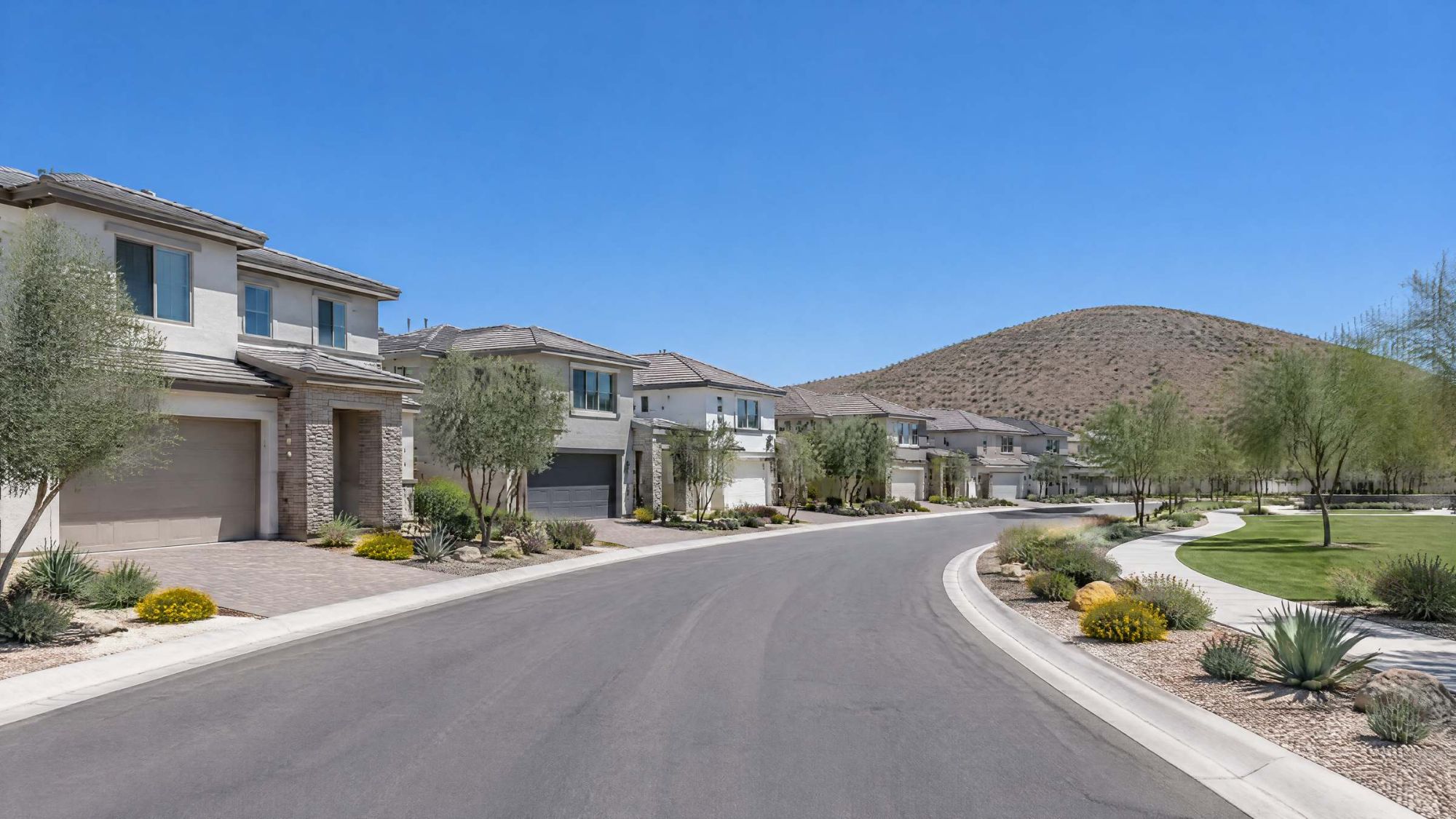 Illustration of two-story desert homes with a rounded brown hill behind them.